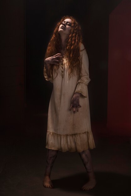 Spooky ginger female zombie in a dress