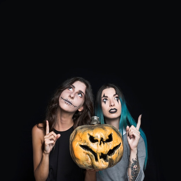 Foto gratuita ragazze spettrali con jack-o-lantern