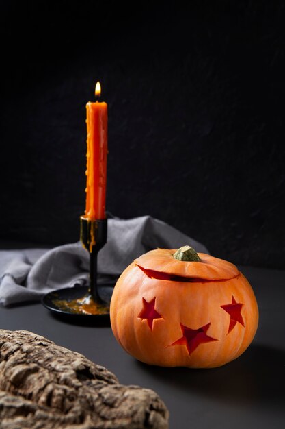 Spooky halloween carved pumpkin lantern with candelabra