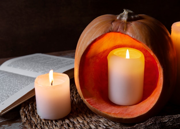 Spooky halloween carved pumpkin lantern with lit candles