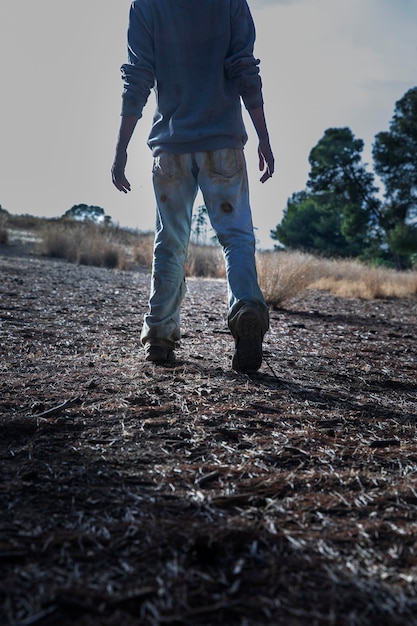 Spooky male zombie outdoors