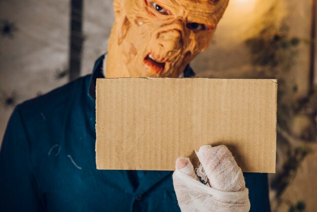 spooky man showing small tablet