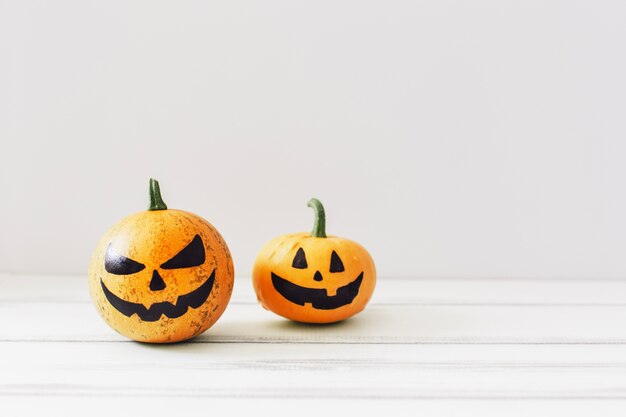 Spooky pumpkins on white background