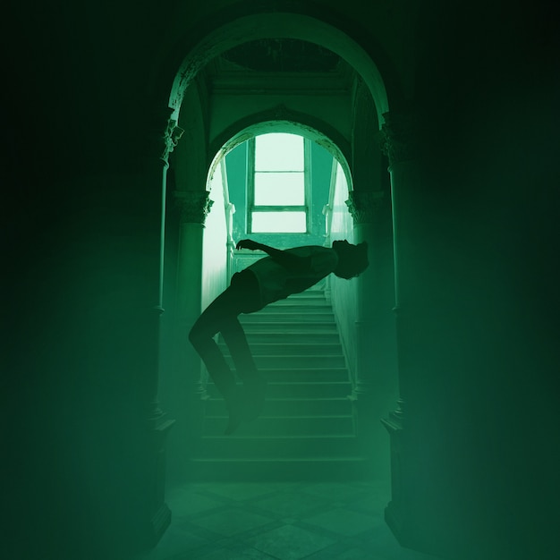 Free photo spooky scene with man floating indoors