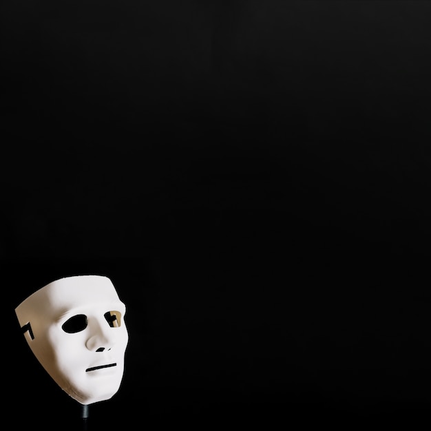 Spooky white mask on black