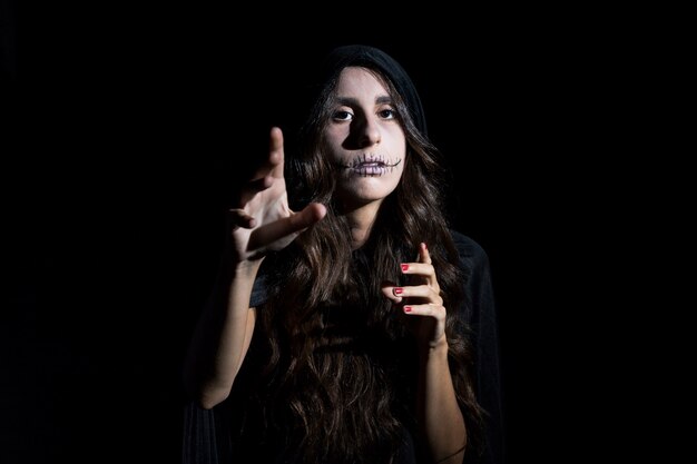 Spooky young woman with scarecrow makeup