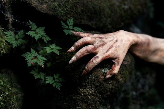 Free photo spooky zombie hand in nature