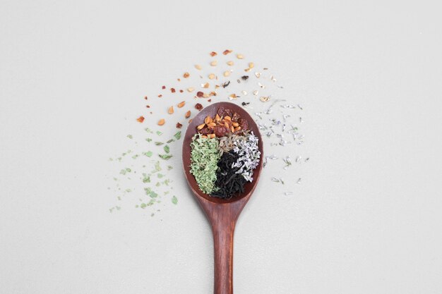 Spoon aroma with spices on white