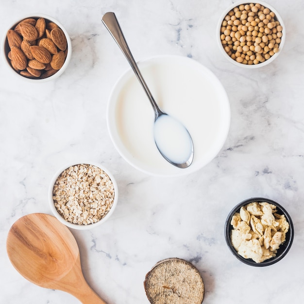 Spoon on bowl with milk on table 