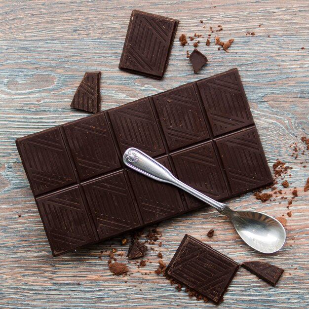 Spoon and dark chocolate bar