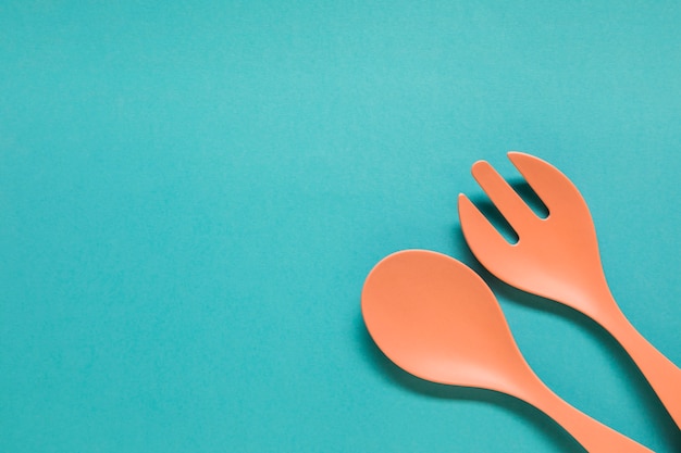 Spoon and fork on blue background 