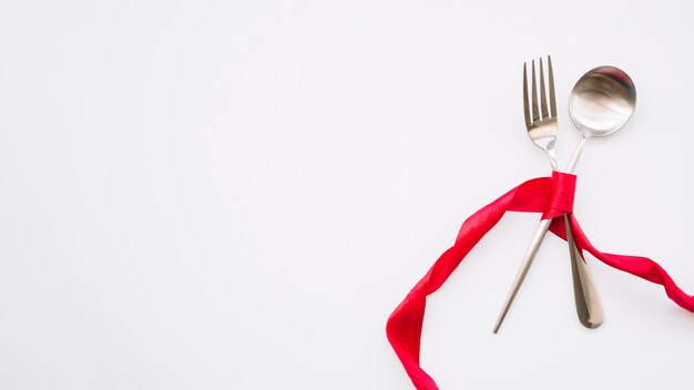 Spoon and fork with red ribbon