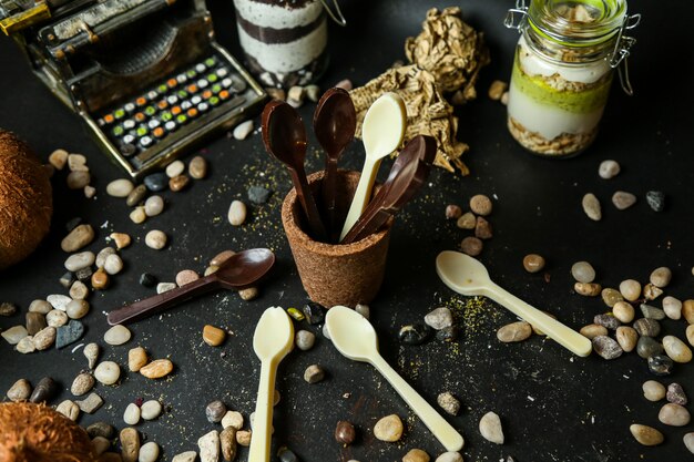 Spoon form black and white chocolates side view