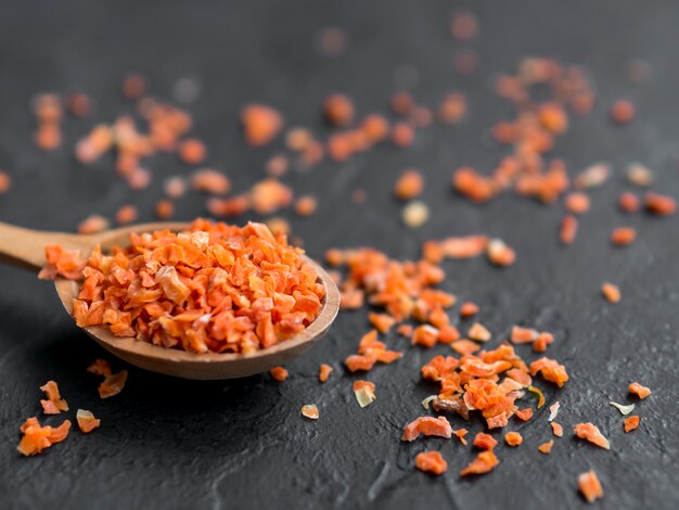 Spoon full of spices on black background