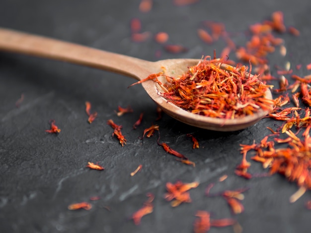 Spoon full of spices on black background