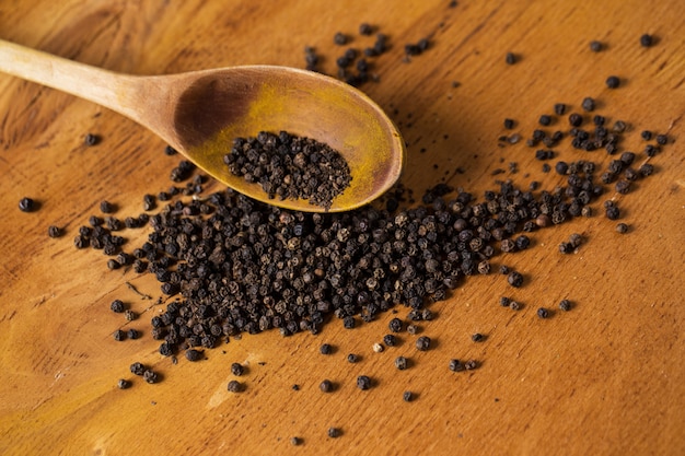 Free photo spoon and heap of pepper on the table