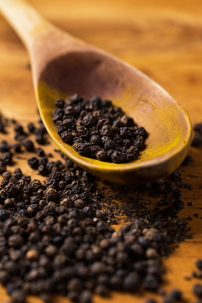 Spoon and heap of pepper on the table