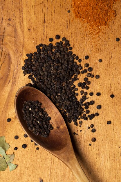 Spoon and heap of pepper on the table