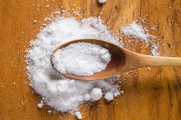 Spoon and heap of salt on the table