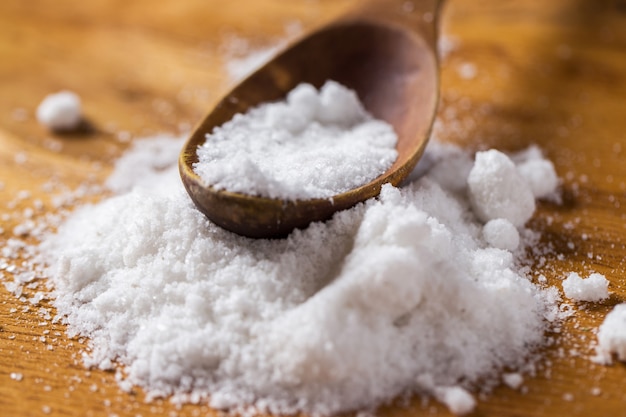 Free photo spoon and heap of salt on the table