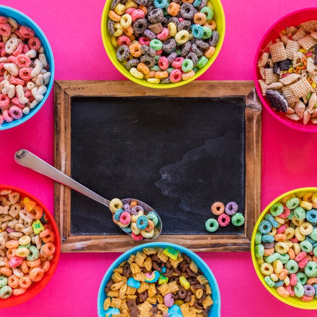Spoon with cereal on chalkboard 