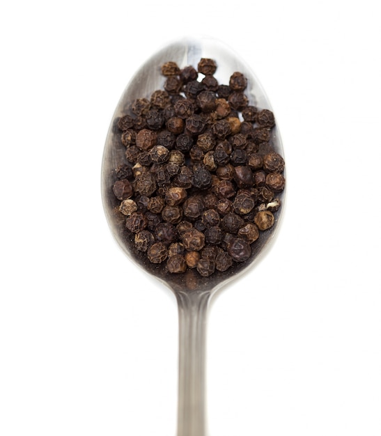 Spoon with spices and white background