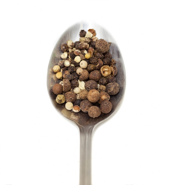 Spoon with spices and white background