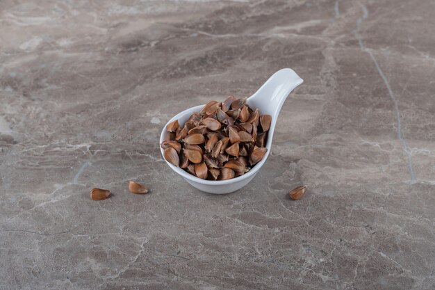 Free photo a spoonful of tasty kernel on the marble surface