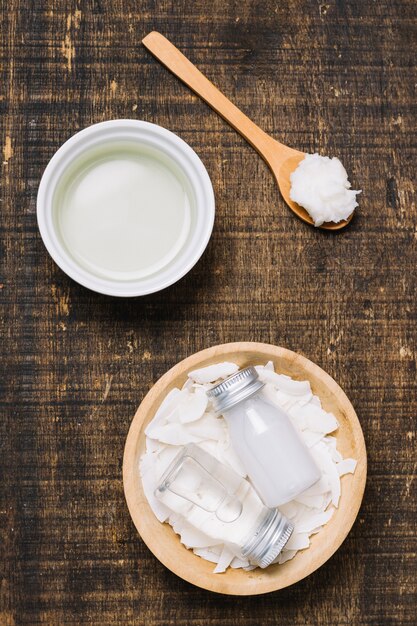 Spoonfull with bowls of coconut oil top view