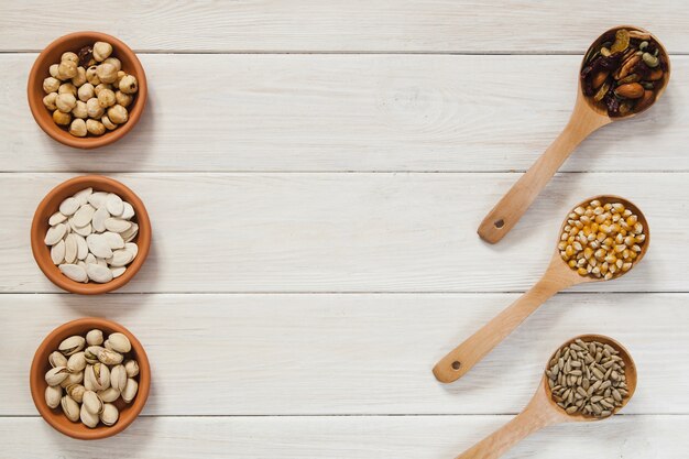 Spoons and bowls with nuts and seeds