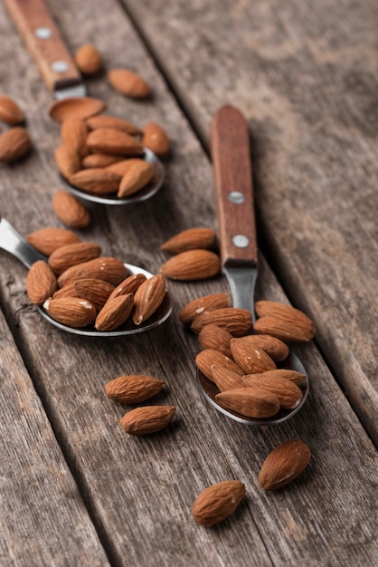 Spoons filled with almond nuts high view