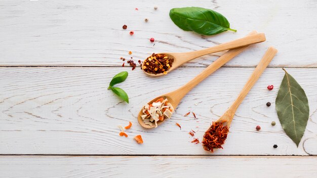 Spoons full spices with dry leaves