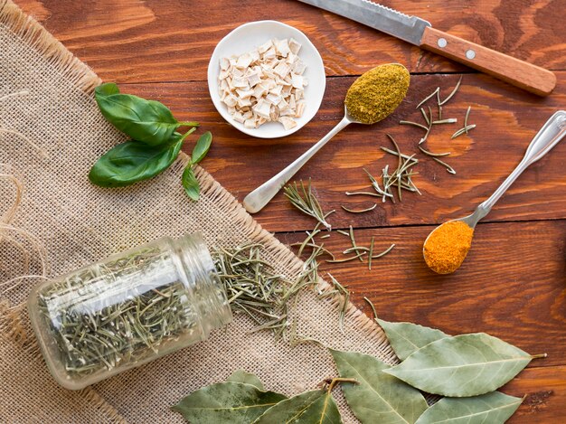 Spoons full spices with dry leaves