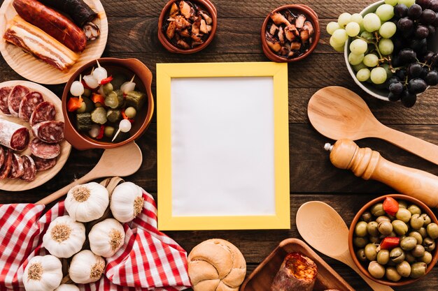 Spoons and napkin near food and frame