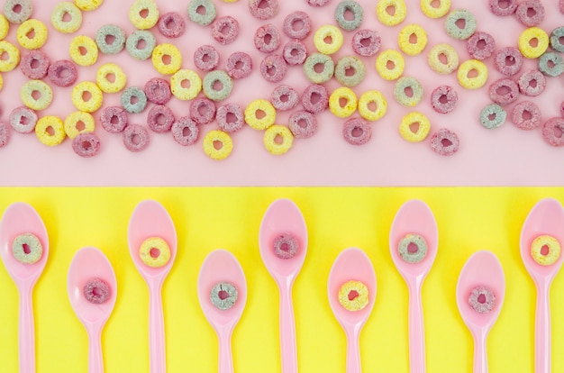 Free photo spoons with fruit loop cereals top view