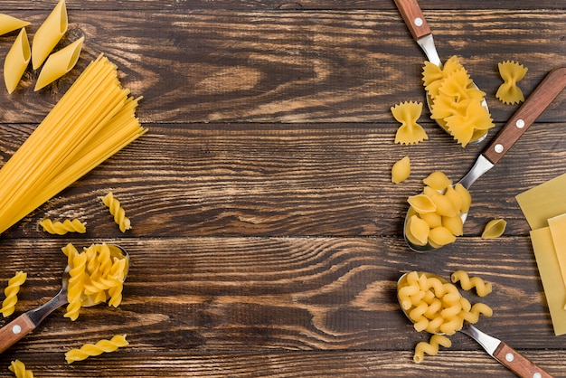 Free photo spoons with pasta on table