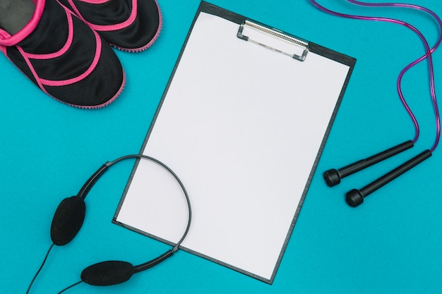 Sport equipment and clipboard with blank sheet