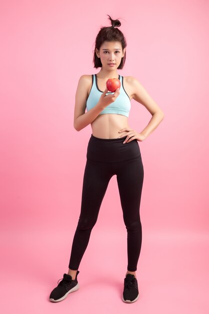 Sport healthy woman holding a red apple