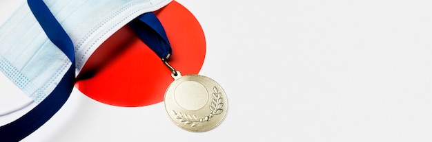 Sport medal next to medical mask with copy space