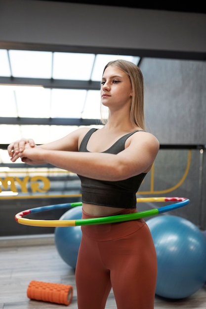 Free photo sport person training with hula hoop