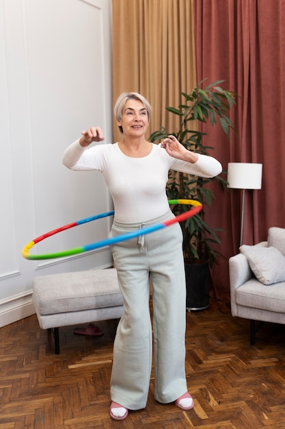 Free photo sport person training with hula hoop