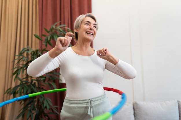 Free photo sport person training with hula hoop