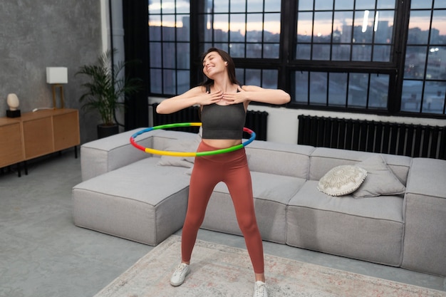 Free photo sport person training with hula hoop