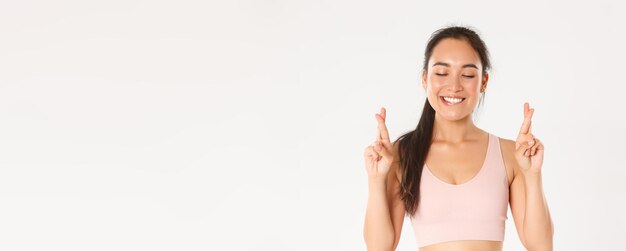 Sport wellbeing and active lifestyle concept closeup of happy smiling asian girl in sportswear makin