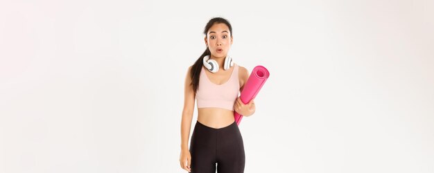 Sport wellbeing and active lifestyle concept confused and shocked asian fitness girl cant understand