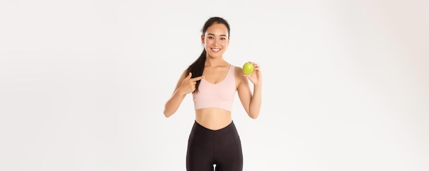 Sport wellbeing and active lifestyle concept portrait of smiling slim and fit asian fitness girl wor