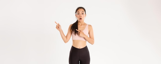 Sport wellbeing and active lifestyle concept surprised and amazed asian girl in fitness clothing poi