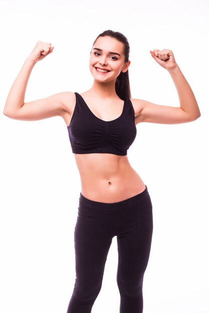Sport young woman with perfect body showing biceps, fitness girl studio shot over white background