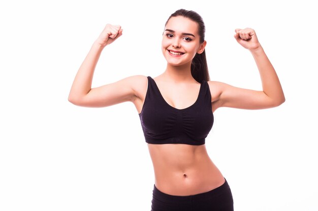 Sport young woman with perfect body showing biceps, fitness girl studio shot over white background