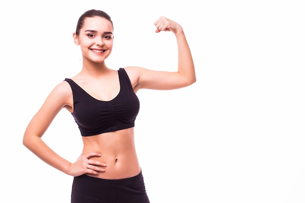 Sport young woman with perfect body showing biceps, fitness girl studio shot over white background